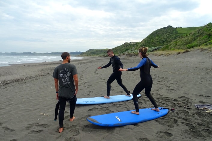 Learning to pop up on the beginner surf course.